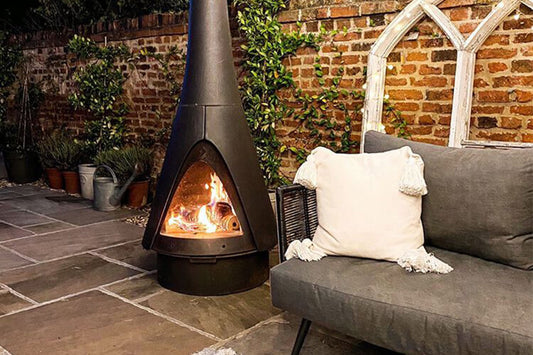 Chiminea next to a sofa on tiled flooring