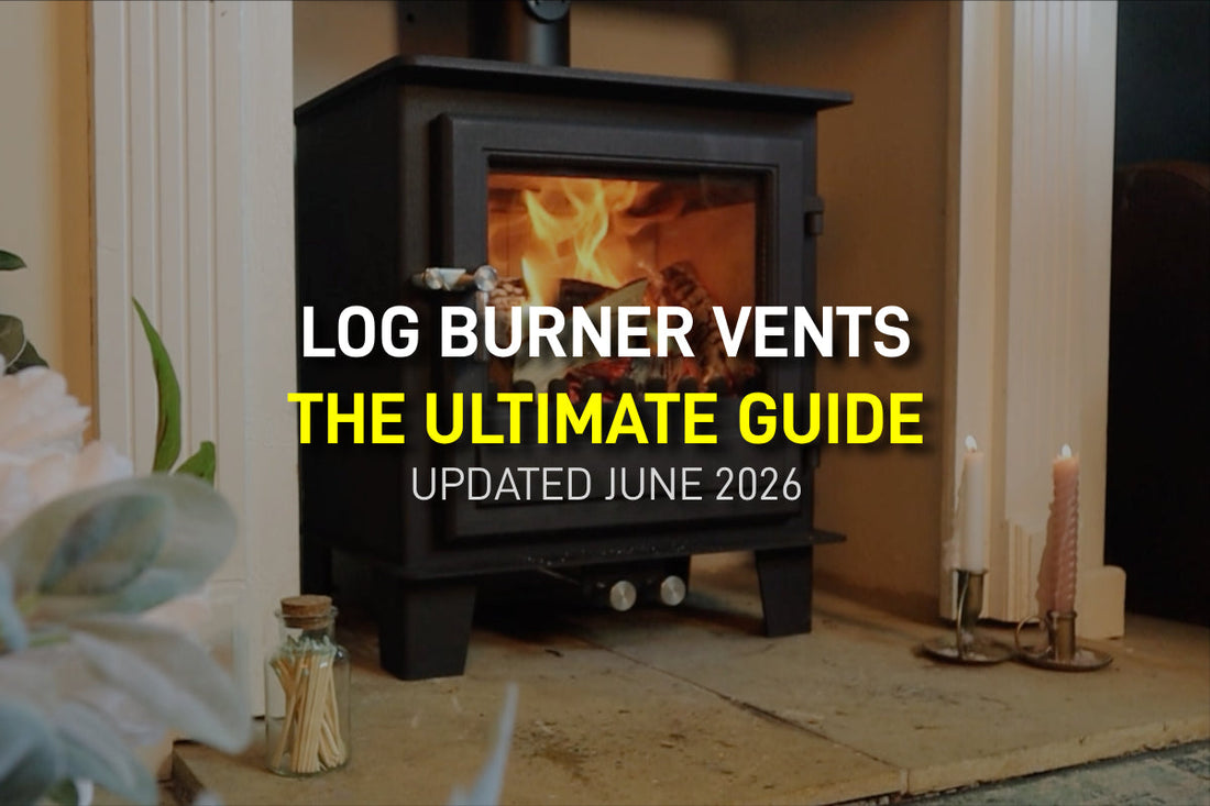 A modern black wood-burning stove with a bright fire burning inside, featuring overlay text that reads: Log Burner Vents: The Ultimate Guide. Updated June 2026.