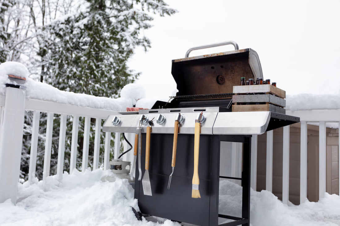 Prepped BBQ on decking surrounded by snow