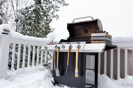 Prepped BBQ on decking surrounded by snow