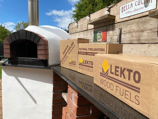 Natural Firelighters and Kiln Dried firewood next to an outdoor pizza oven  