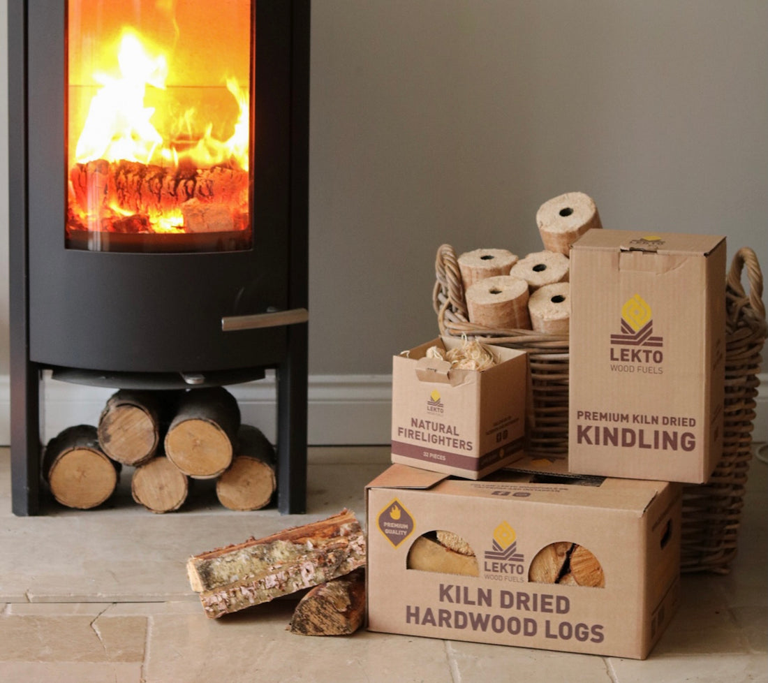Lekto Wood Fuel Kindling, and Kiln Dried Hardwood Logs next to a wood-burning stove
