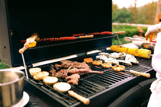 variety of meat and vegetables grilling on a BBQ